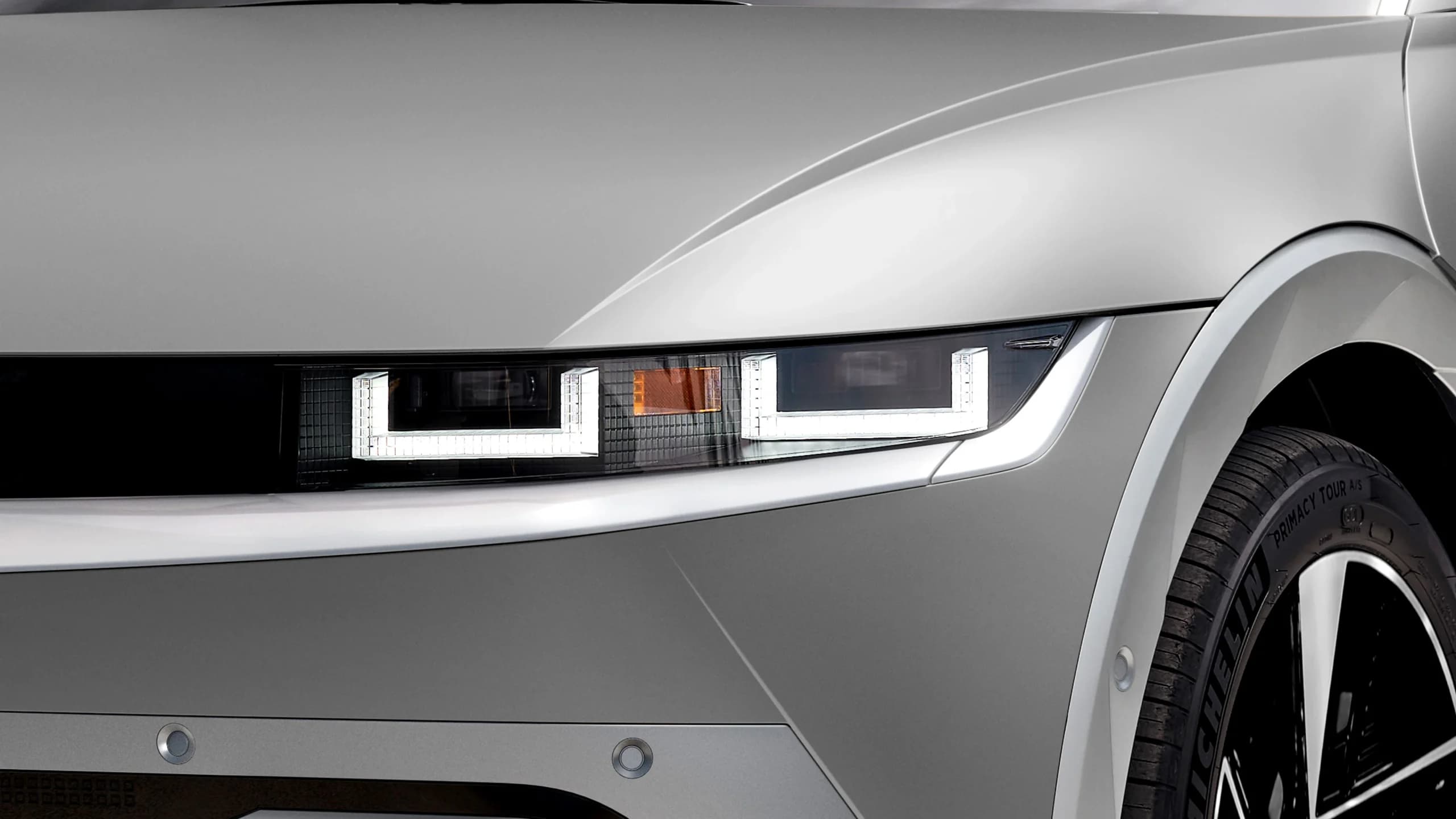 Close-up of the Hyundai IONIQ 5's front end, showing its pixel-cluster headlight — the vehicle platform behind EVON's fleet.